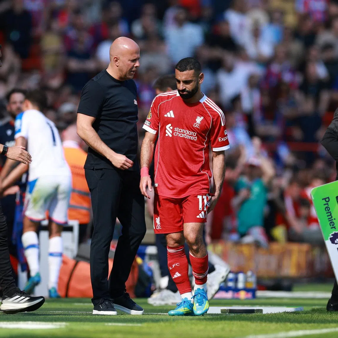Soccer Football - Premier League - Liverpool v Crystal Palace - Anfield, Liverpool, Britain - April 25, 2026 Liverpool's Mohamed Salah with manager Arne Slot after being substituted REUTERS/Phil Noble