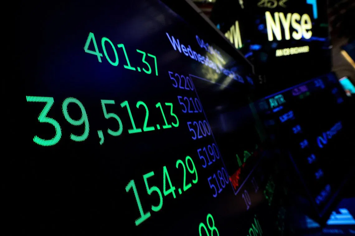 A screen displays the Dow Jones Industrial Average after the close of trading for the day on the floor at the New York Stock Exchange (NYSE) in New York City, U.S., March 20, 2024. REUTERS/Brendan McDermid