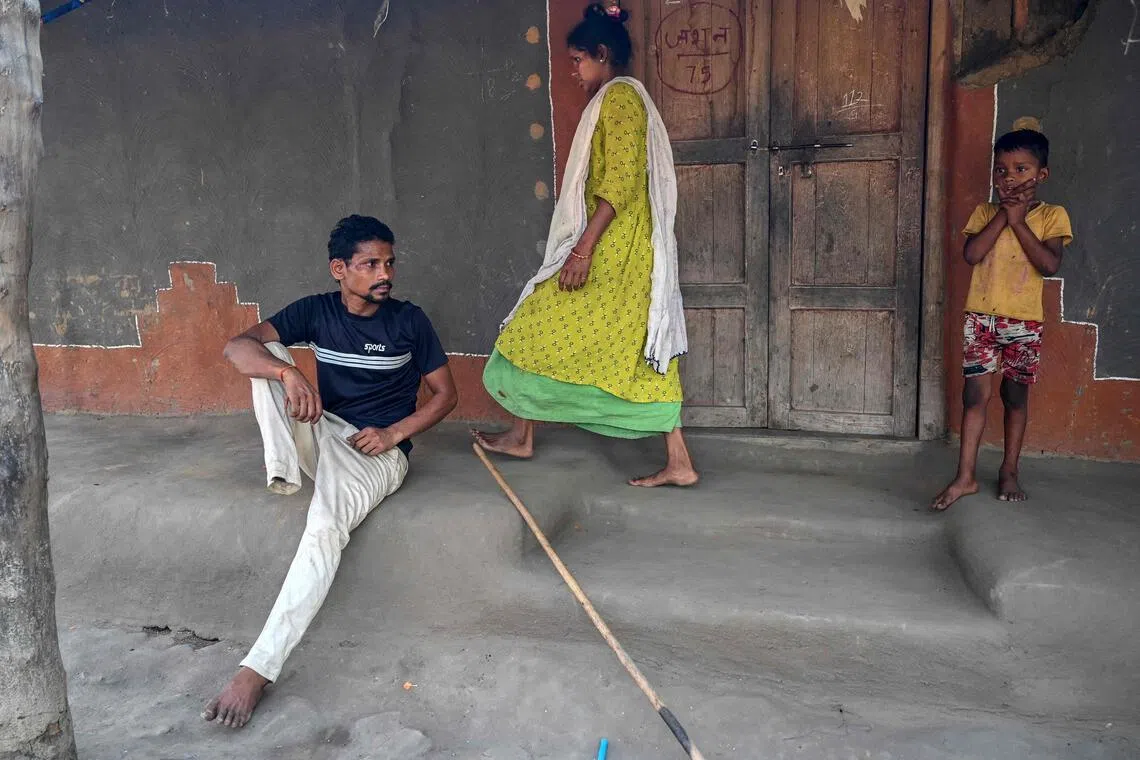 Mr Raju Modiyam (left), a tribal resident who lost a leg in a landmine explosion, rests as his wife Jayamma (centre) and child look on at their residence in the Lankapalli village of Chhattisgarh’s Bijapur district on April 1. 