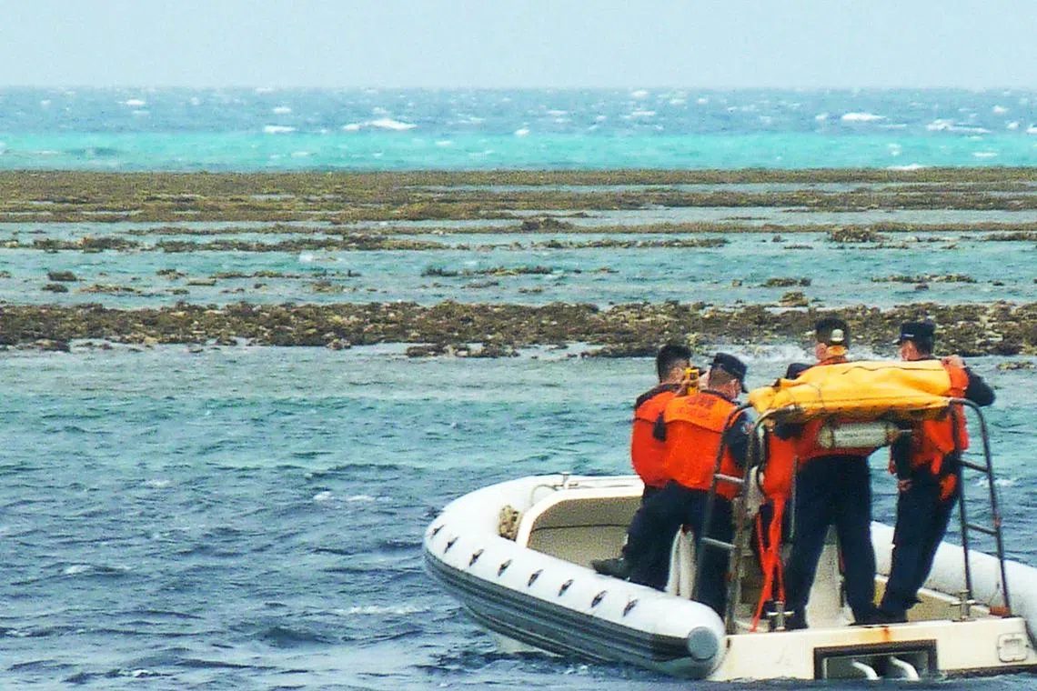 In this photo taken on December 25, 2022, Chinese coast personnel aboard an inflatable boat patrol Scarborough Shoal in the South China Sea. (Photo by AFP)