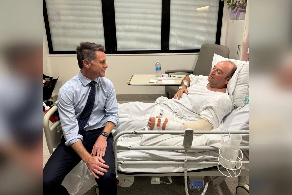 New South Wales Premier Chris Minns visiting Mr Ahmed al Ahmed at a hospital in Sydney on Dec 15.