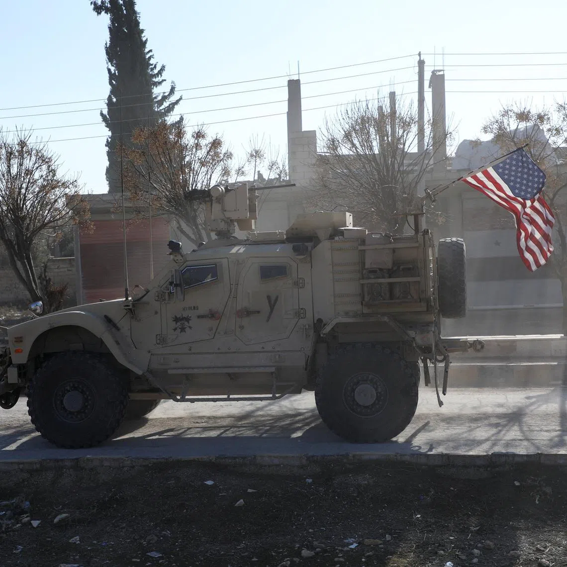 FILE PHOTO: A U.S. military vehicle moves on a road on the day of a meeting between the Syrian Democratic Forces (SDF) leaders and U.S. military leaders, in Deir Hafer, Syria. January 16, 2026. REUTERS/Orhan Qereman/ File Photo