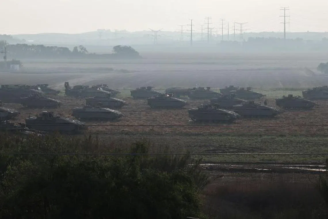 Israeli tanks and military vehicles take position near Israel's border with the Gaza Strip, in southern Israel, October 14, 2023. REUTERS/Violeta Santos Moura