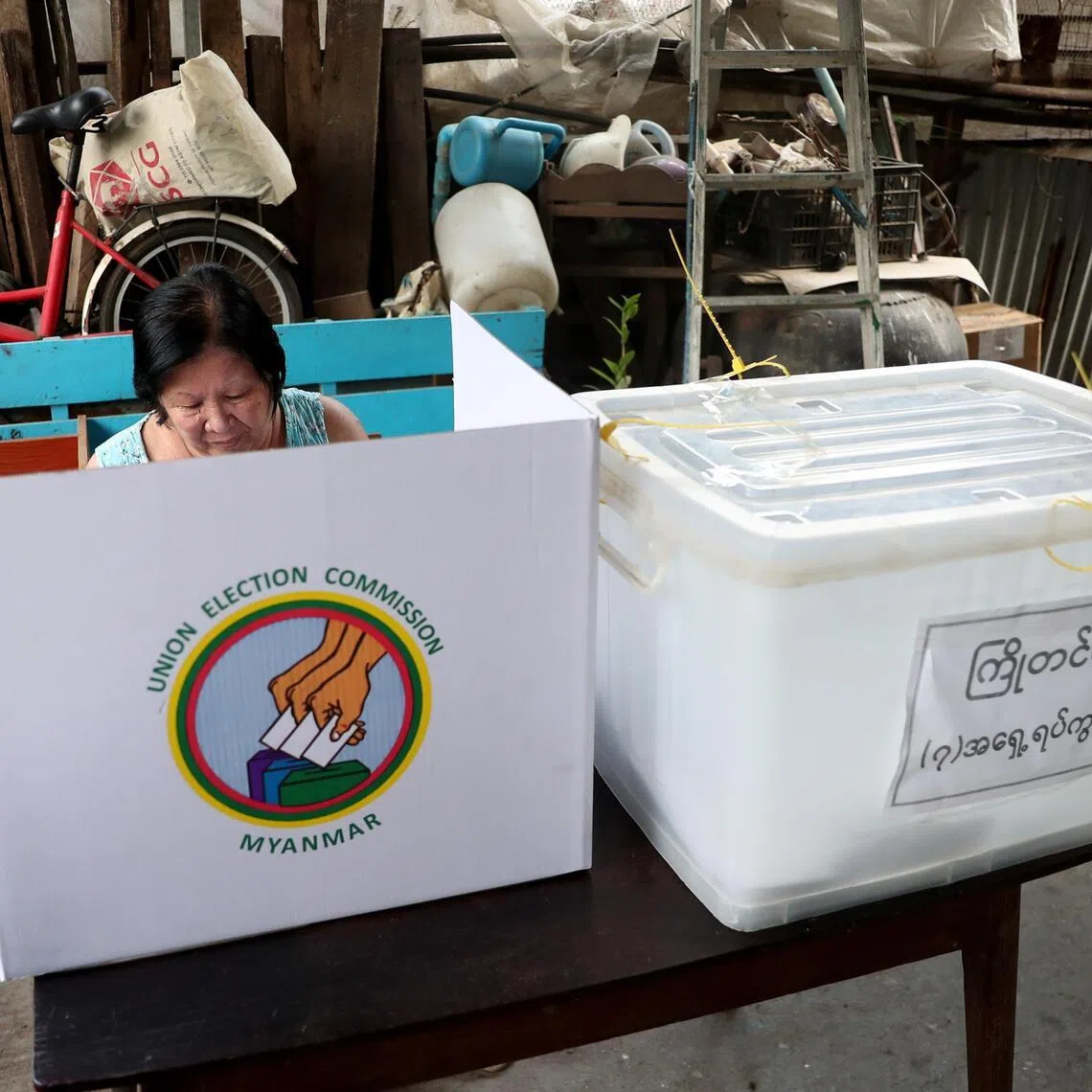 A woman casts her advance vote at her house ahead of the third phase of the general election in Yangon, Myanmar.