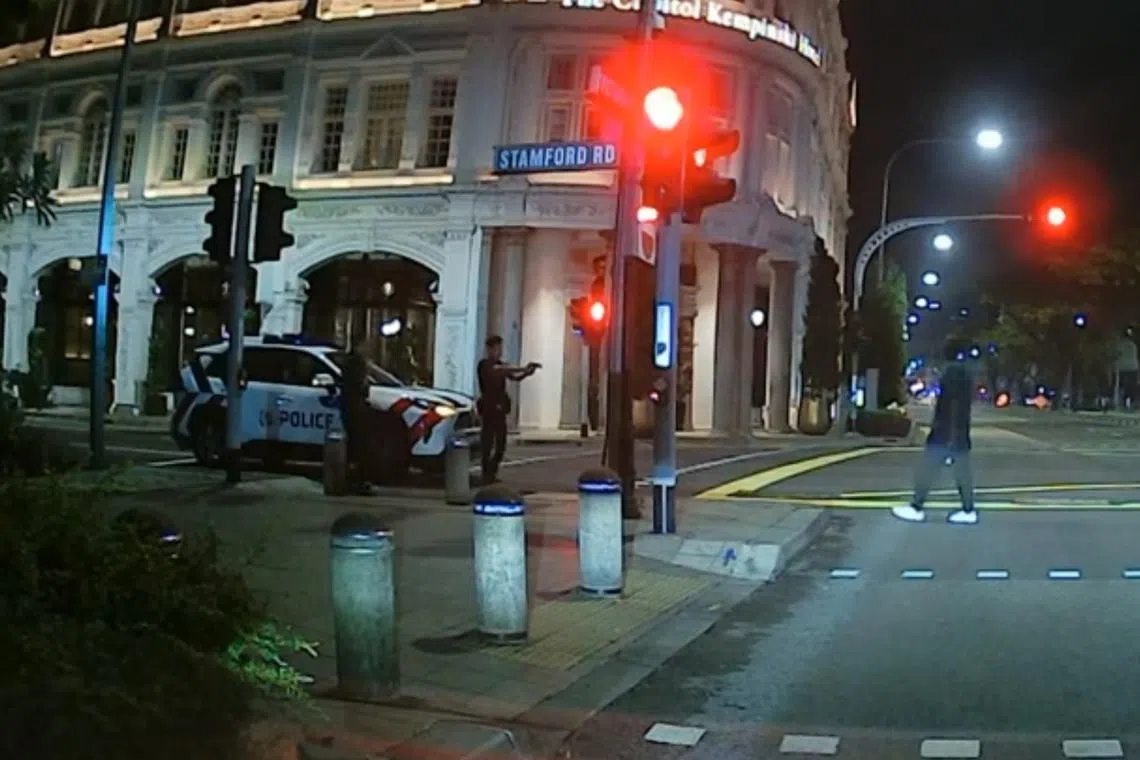 In a video posted on YouTube, the man is seen walking steadily towards a police car while holding the axe in his right hand.