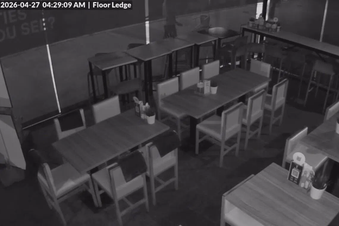 The men can be seen throwing chairs at the exterior of the store and at the hoarding barrier across the eatery.