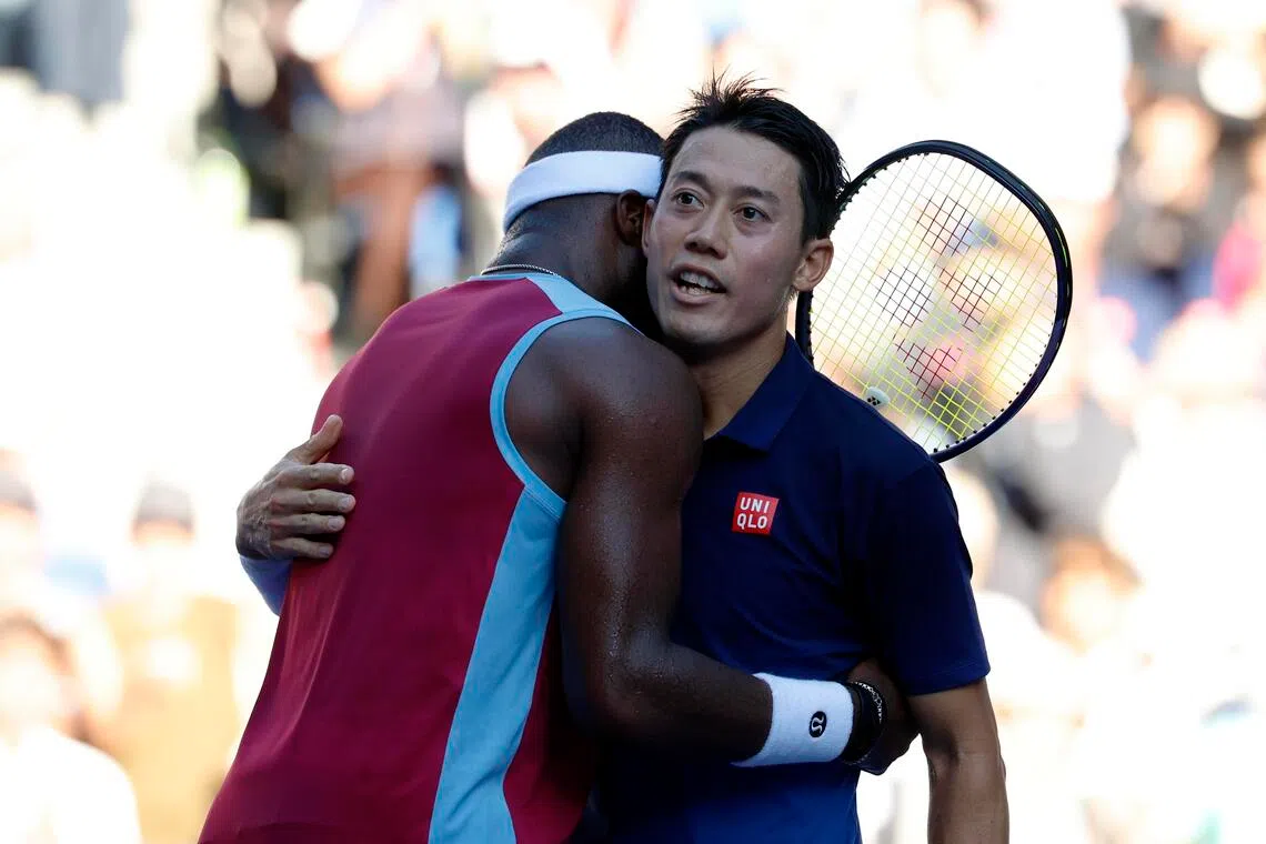 Kei Nishikori of Japan and Frances Tiafoe of the US hug after their round-of-32 match at the Japan Open on Oct 1.