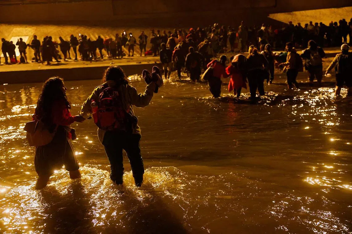 Migrants, mostly from Nicaragua who were kidnapped by organized crime in the state of Durango and released days later by the Mexican Army, cross the Rio Bravo river to turn themselves in to U.S. Border Patrol agents to request asylum in El Paso, Texas, U.S., as seen from Ciudad Juarez, Dec 11, 2022. 
