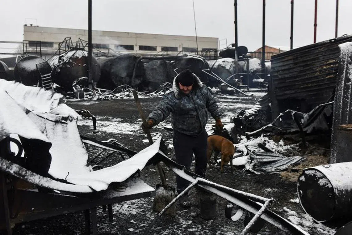 FILE PHOTO: A man inspects damage at an oil depot hit by recent shelling in the course of Russia-Ukraine conflict in Donetsk, Russian-controlled Ukraine, December 7, 2023. REUTERS/Valery Melnikov/File Photo