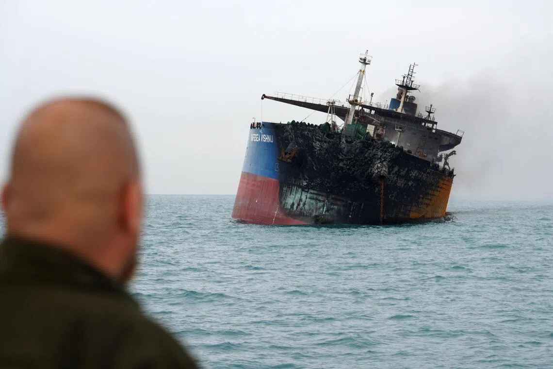 An oil tanker is seen listing to one side after it was attacked and set ablaze off Iraq’s coast.
