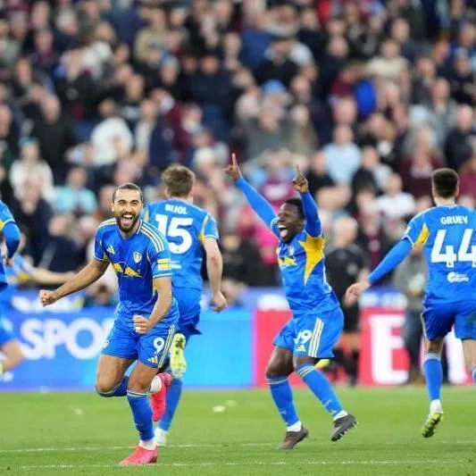 Leeds United's English striker Dominic Calvert-Lewin (second from left) and teammates celebrate after winning the shoot-out.