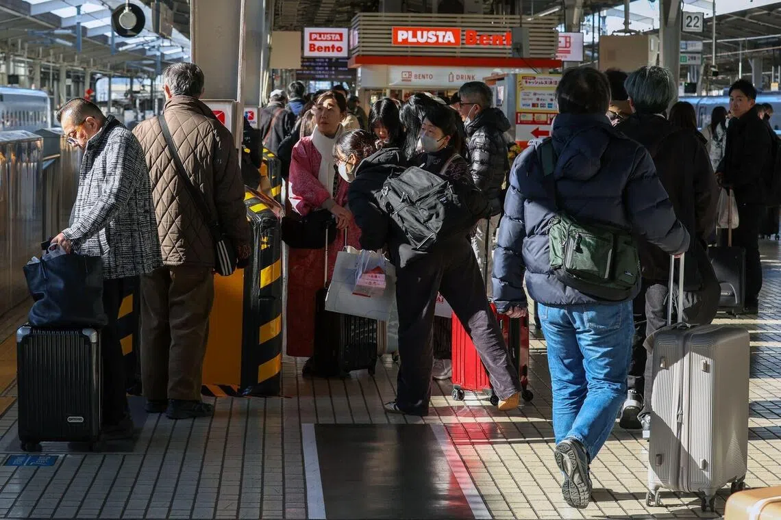 Travellers crowd a platform at the Shin-Osaka station in Osaka, as the long holiday starts in Japan.
