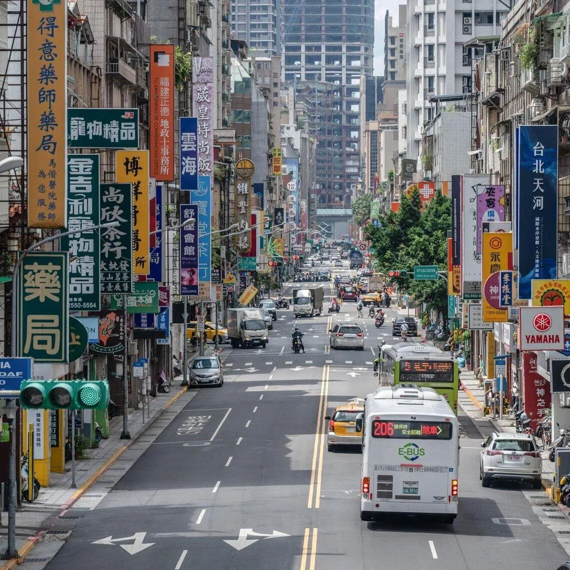 Store signs along a road in Taipei, Taiwan, on Thursday, July 16, 2026.
