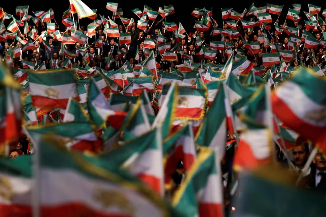 People wave flags during at an event in Ashraf-3 camp, which is a base for the People's Mojahedin Organization of Iran (MEK) in Manza, Albania, July 13, 2019.REUTERS/Florion Goga