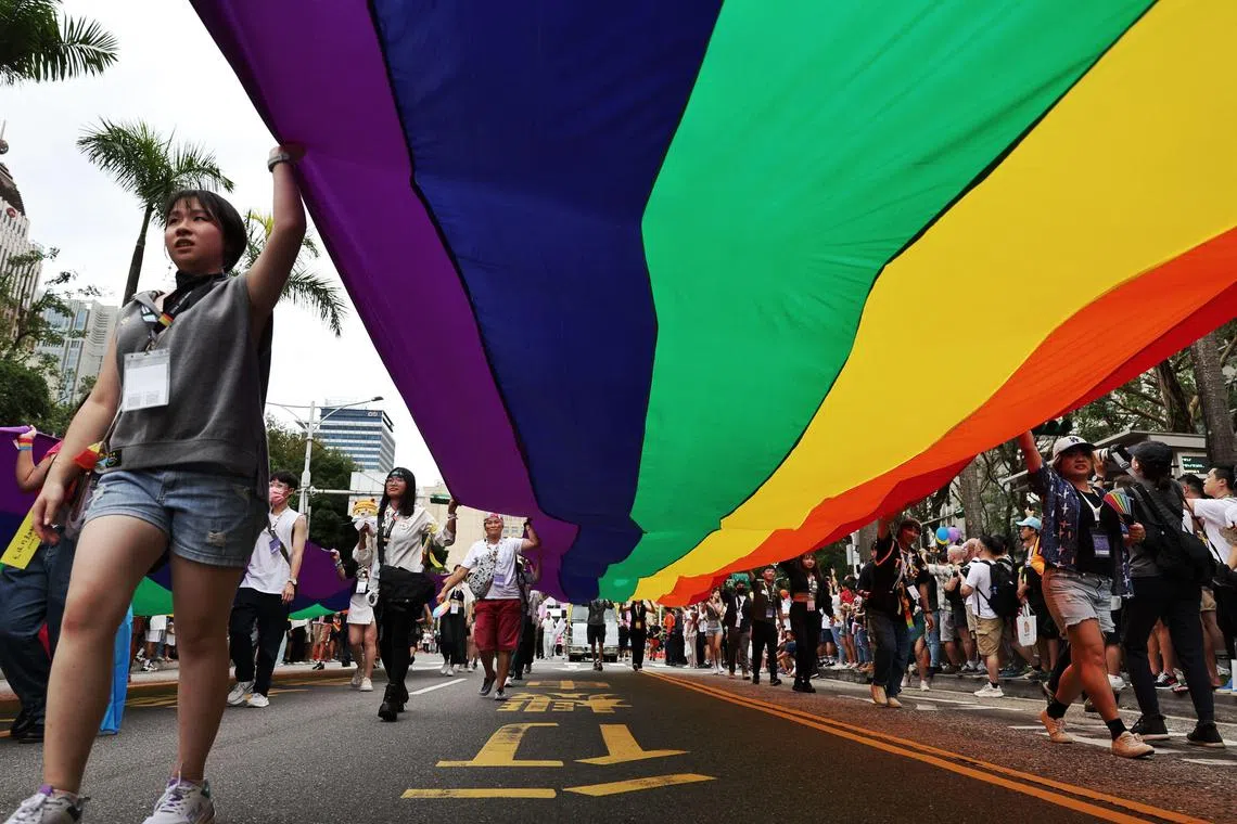 LGBT rights activists carry a large rainbow banner as they march during Taiwan’s annual LGBTQ+ Pride Parade in Taipei.