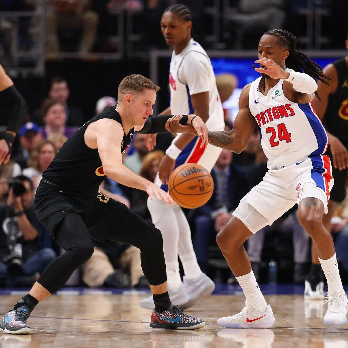 Sam Merrill of the Cleveland Cavaliers works against Daniss Jenkins of the Detroit Pistons during the first quarter in Game 1.