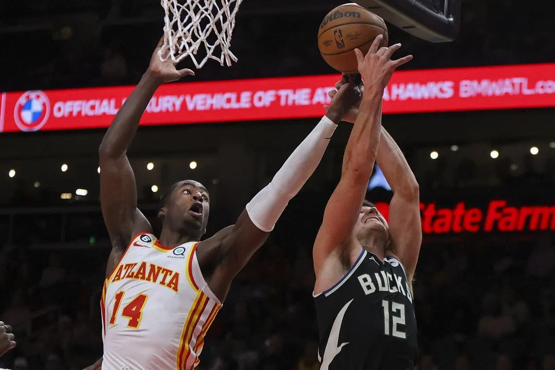 Atlanta Hawks forward AJ Griffin grabbing a rebound past Milwaukee Bucks guard Grayson Allen in the first quarter at State Farm Arena. He scored 24 points from the bench as the Hawks ended the Bucks’ unbeaten start to the season with a 117-98 victory on Monday.