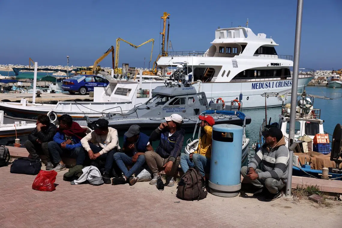 Migrants wait at a fishing shelter in Paralimni, Cyprus, April 5, 2024. REUTERS/Yiannis Kourtoglou/File Photo