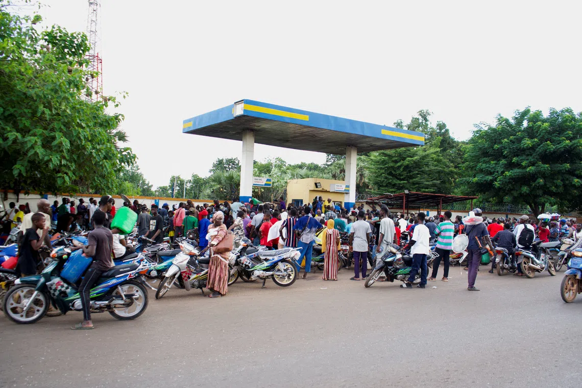 FILE PHOTO: People gather at a petrol station due to shortage of petrol in Bamako, Mali October 7, 2025. REUTERS/Idriss Sangare/File Photo