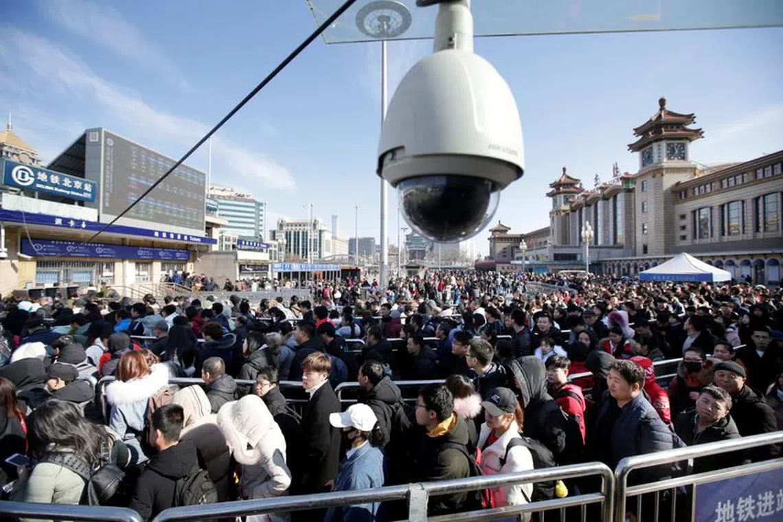 FILE PHOTO: Passengers wait to enter a subway outside Beijing Railway Station, after arriving by train during the Chinese Lunar New Year travel rush as the annual Spring Festival holidays ended in Beijing, China February 11, 2019. REUTERS/Jason Lee/File Photo