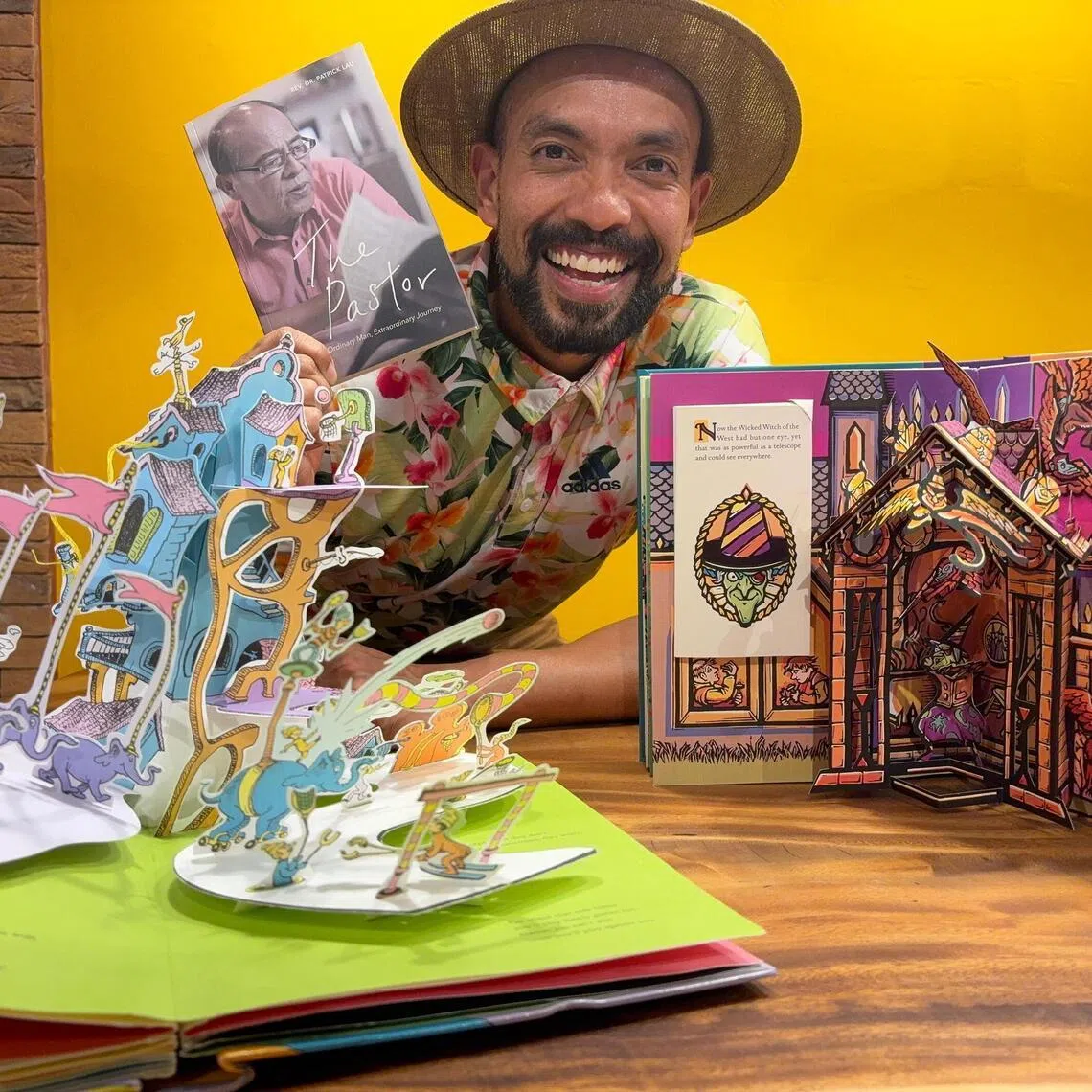 Mr Dwayne Lau is revisiting The Pastor: Ordinary Man, Extraordinary Journey, a memoir by his late father Dr Patrick Lau, alongisde pop-up books he enjoys for their visual storytelling.