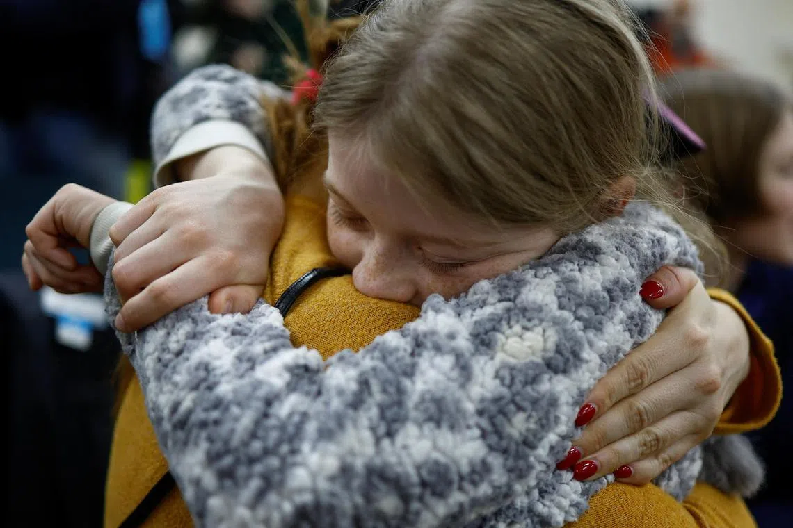 Valeriia embraces her mother, Anastasiia, upon her return to Ukraine after being taken to Russia, in April 2023.