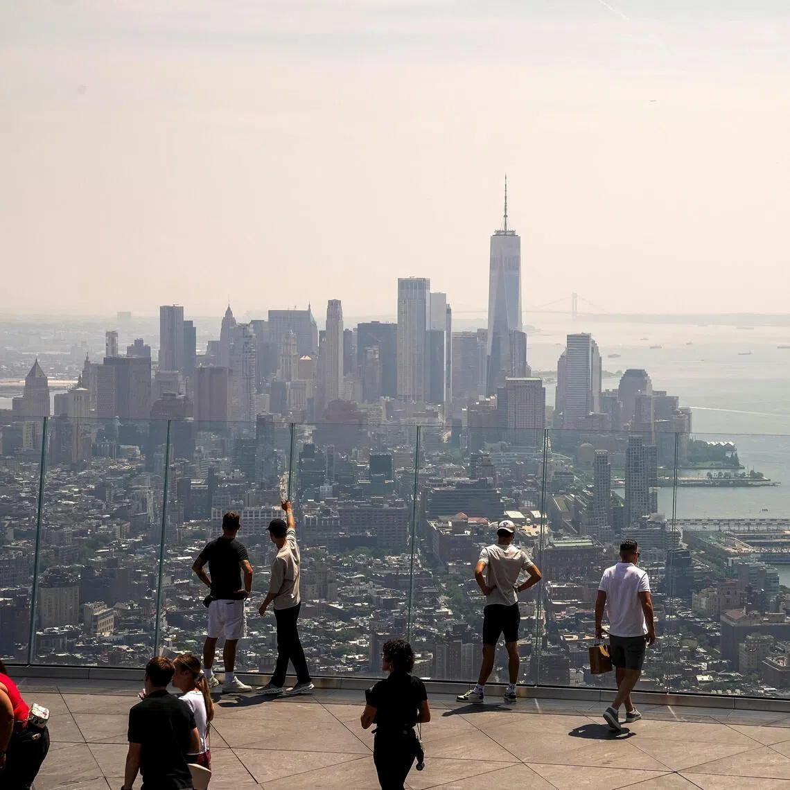 People visiting the Edge observation deck to view the New York City skyline and One World Trade Centre, as wildfire smoke impacts air quality in New York City on July 17.