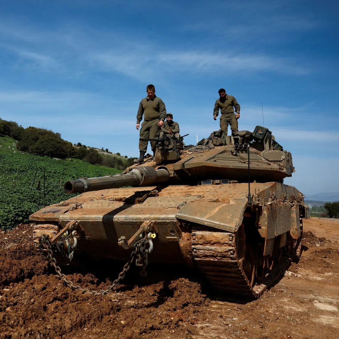 Israeli soldiers stand on a tank on the Israeli side of the border with Lebanon, amid escalation between Hezbollah and Israel, amid the U.S.-Israeli conflict with Iran, in northern Israel, March 6, 2026. REUTERS/Ammar Awad