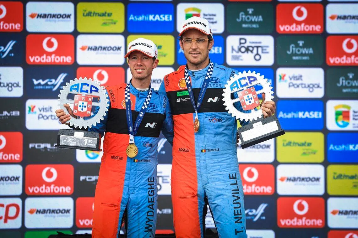 Thierry Neuville (right) and his co-pilot Martijn Wydaeghe celebrate after winning the Portugal Rally, as part of the World Rally Championship (WRC) in Fafe on May 10, 2026.