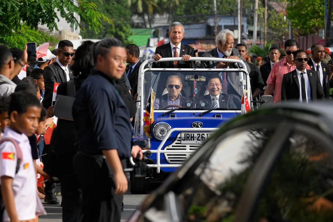 Timor Leste school children line the streets leading to the delegation hotel as Singapore Prime Minister Lawrence Wong (centre) rides on a mini moke driven by Timor Leste president Jos Ramos-Horta from the airport, with Singapore Foreign Minister Vivian Balakrishnan and Timor Leste Prime Minister Xanana Gusmao, on July 2, 2026.