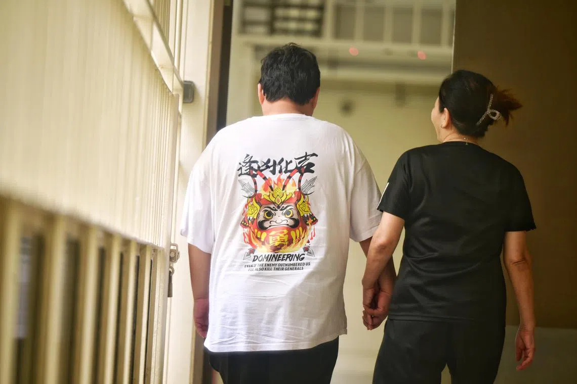 chid05 - (Not their real names) Mr Andy (left), 39, with his mother, Ms Wendy (right), 60, at a photoshoot on Dec 12. Mr Andy, who has an intellectual disability, was jailed 11 times for property-related offences, reoffended twice after his release but was given warnings as he continued with his rehabilitation. 

ST PHOTO: AZMI ATHNI