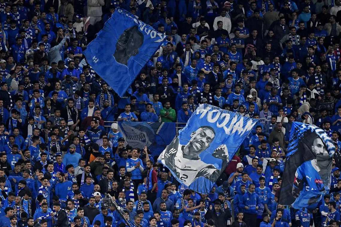 Soccer Football - Saudi Pro League - Al Hilal v Al Ittihad - Kingdom Arena, Riyadh, Saudi Arabia - March 1, 2024 Al Hilal fans wave a flag of Malcom during the match REUTERS/Stringer/File Photo