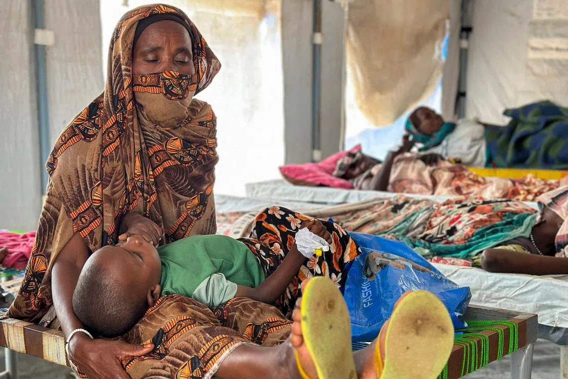 Patients infected with cholera receive treatment at a refugee camp in western Sudan.