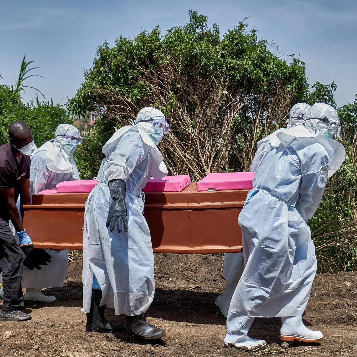 Red Cross workers wearing personal protective equipment (PPE) carry the coffin of a man who died of Ebola virus before his burial in Bunia, Ituri province, in the Democratic Republic of Congo, on June 10, 2026. 