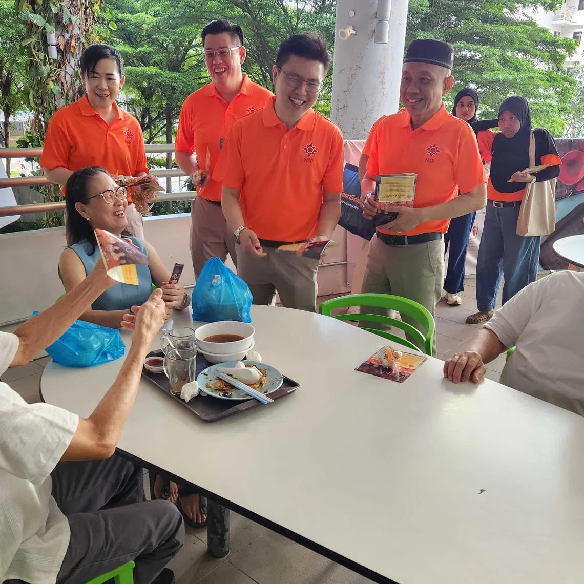 (From left) NSP's Sembawang GRC candidates Verina Ong, Raiyian Chia, Spencer Ng and Yadzeth Hairis on a walkabout at Kampung Admiralty Hawker Centre on April 24.