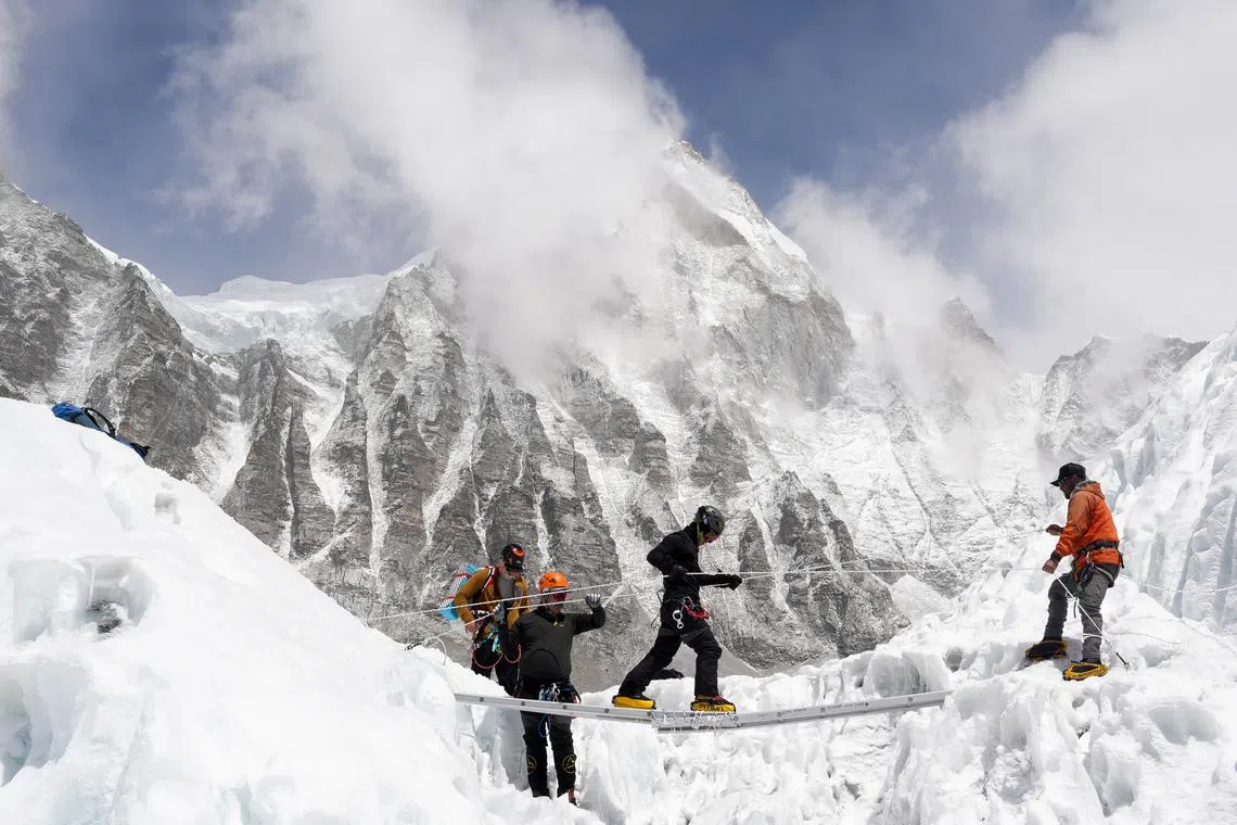 FILE PHOTO: Mountaineers practice walking on a ladder during a training session at Everest base camp, Nepal April 15, 2025. REUTERS/Purnima Shrestha/File Photo