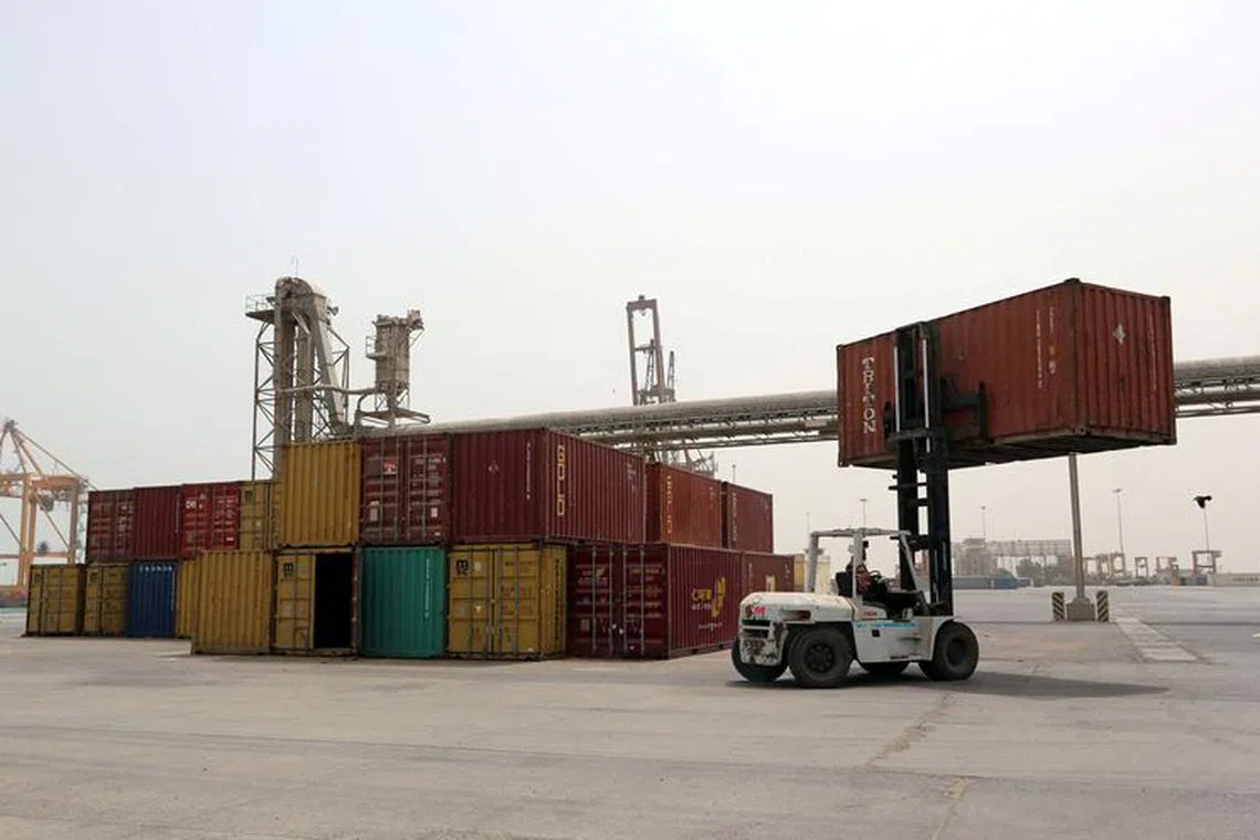 FILE PHOTO: A forklift carries a shipping container at the Red Sea port of Hodeidah, Yemen June 24, 2018. REUTERS/Abduljabbar Zeyad/File Photo
