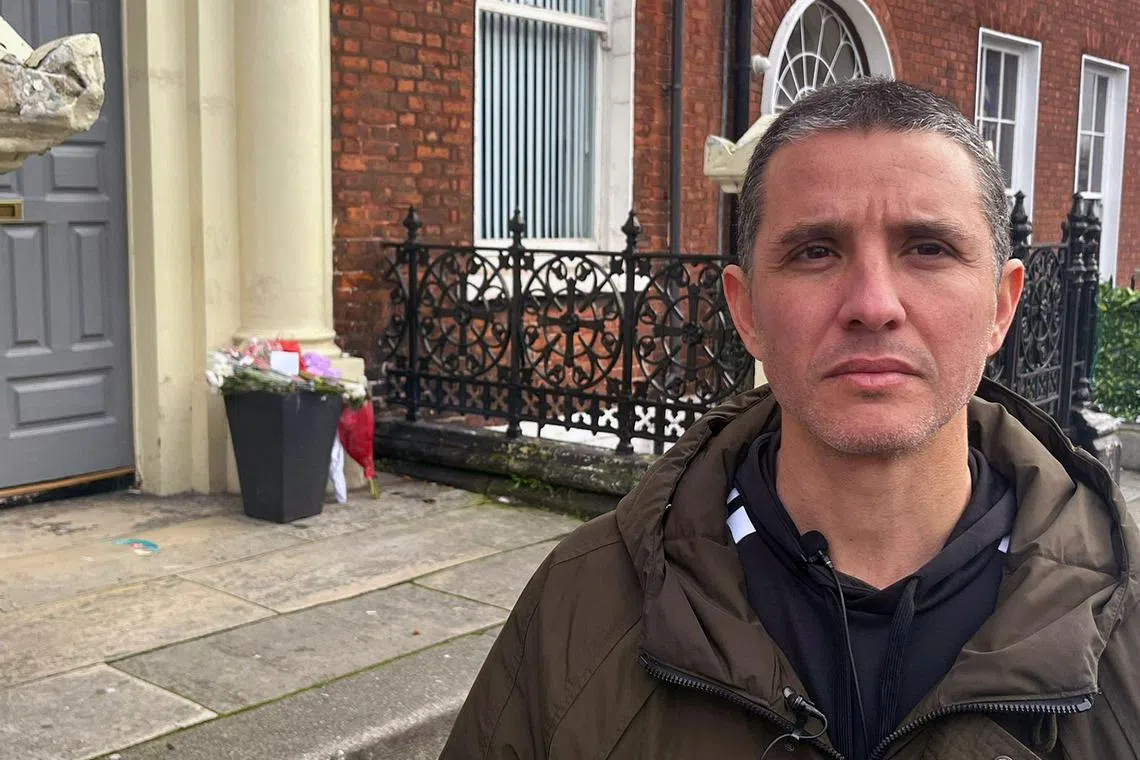 Brazilian Caio Benicio poses for a photograph during an interview with AFP, at the scene of the November 23 attack outside a school on Parnell Square East, in Dublin on November 25, 2023. Benicio, a Brazilian driver for the Deliveroo takeaway app, used his motorcycle helmet to stop an attacker as he allegedly stabbed three children and a woman outside a school. A five-year-old girl sustained serious injuries and remains in hospital.  Two other children and two adults -- a woman and the suspected perpetrator -- were taken to hospital with lesser injuries. (Photo by Peter MURPHY / AFP)