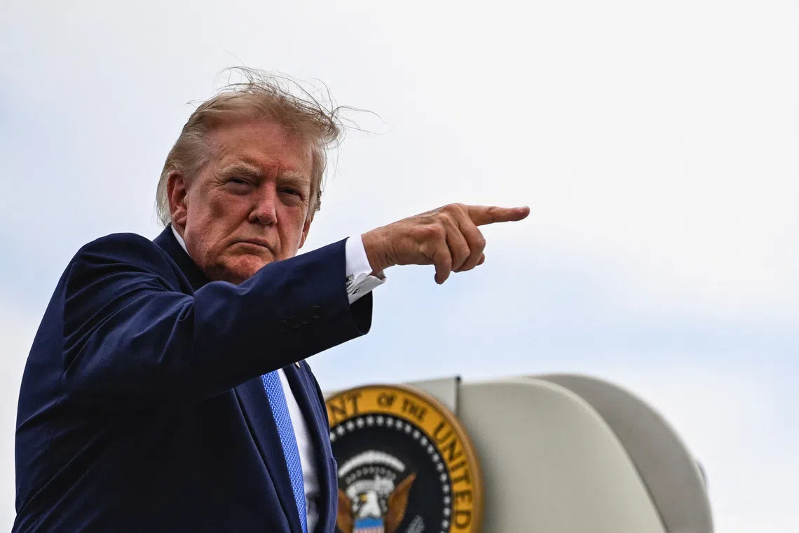 US President Donald Trump points a finger as he boards Air Force One at Morristown Municipal Airport in Morristown, New Jersey, Aug 2, 2026.