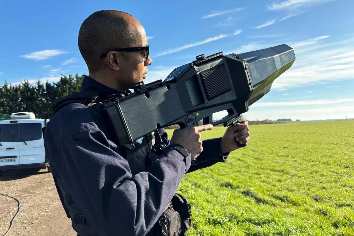 A French police officer poses with an anti-drone rifle during an exercise to test out their anti-drone defence equipment ahead of playing host to the Summer Olympics at the military airbase of Villacoublay, near Paris, France, March 14, 2024. REUTERS/Julien Pretot/File Photo