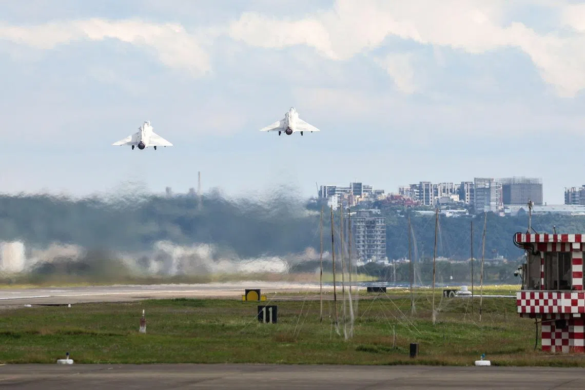 Taiwanese fighter jets take off at an Air Force base in Hsinchu, as Chinese warplanes and ships gather around Taiwan.