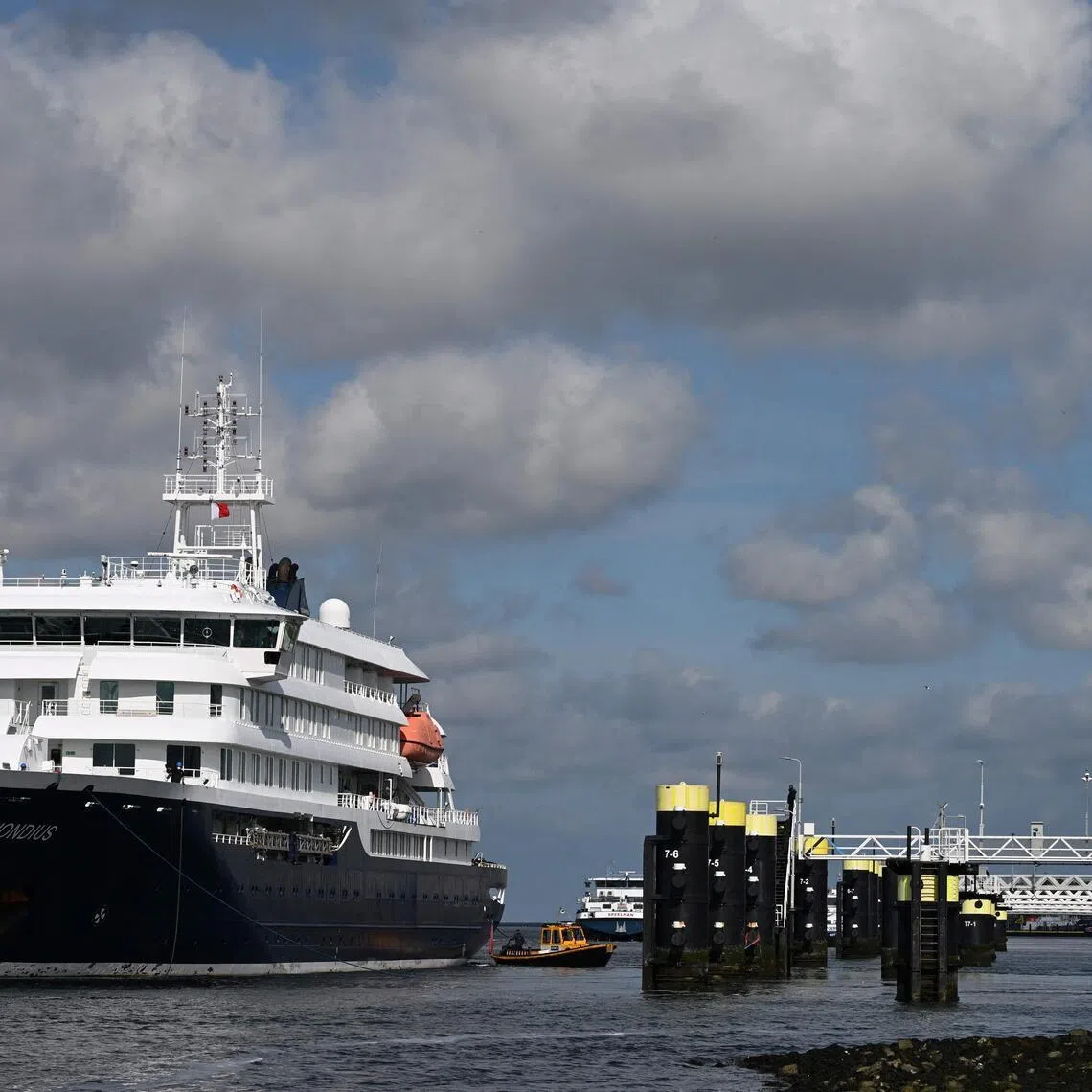 (FILES) The Dutch Hantavirus-hit cruise ship MV Hondius arrives to dock at the port of Rotterdam on May 18, 2026. The UN health agency on July 2, 2026 declared an end to the deadly hantavirus outbreak on a cruise ship which sparked international alarm, after the last person left quarantine. World Health Organization (WHO) chief Tedros Adhanom Ghebreyesus told a press conference he was "very pleased to say that WHO considers the outbreak of hantavirus over". (Photo by Nicolas TUCAT / AFP)