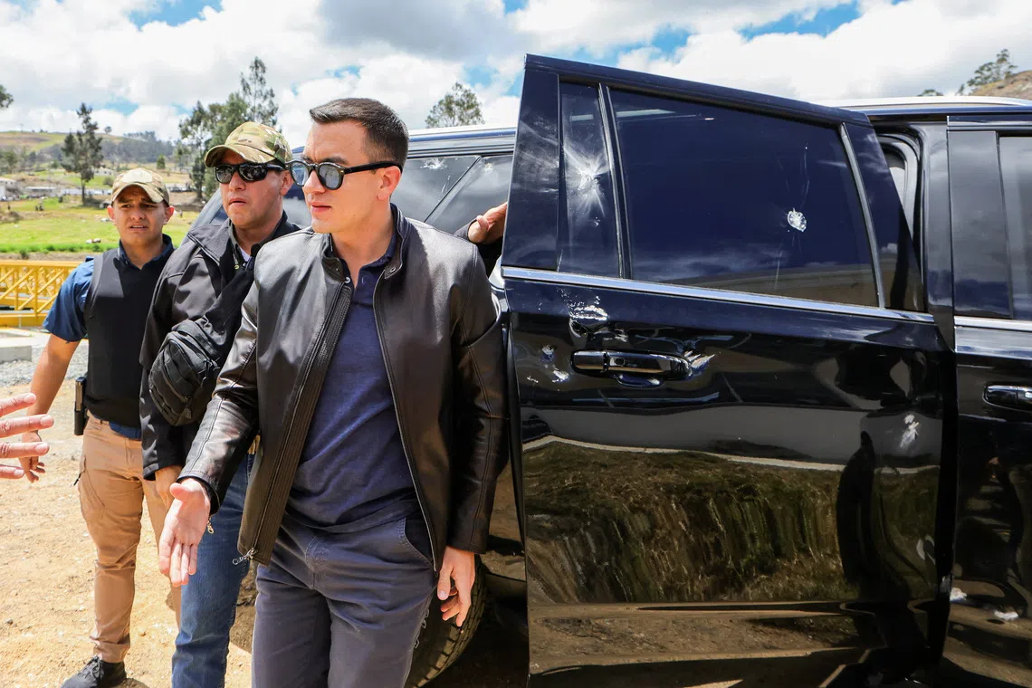 Ecuador's President Daniel Noboa stands next to a car showing signs of damage after his motorcade was attacked by a crowd throwing rocks, in El Tambo, Ecuador October 7, 2025. Ecuador Presidency/Handout via REUTERS