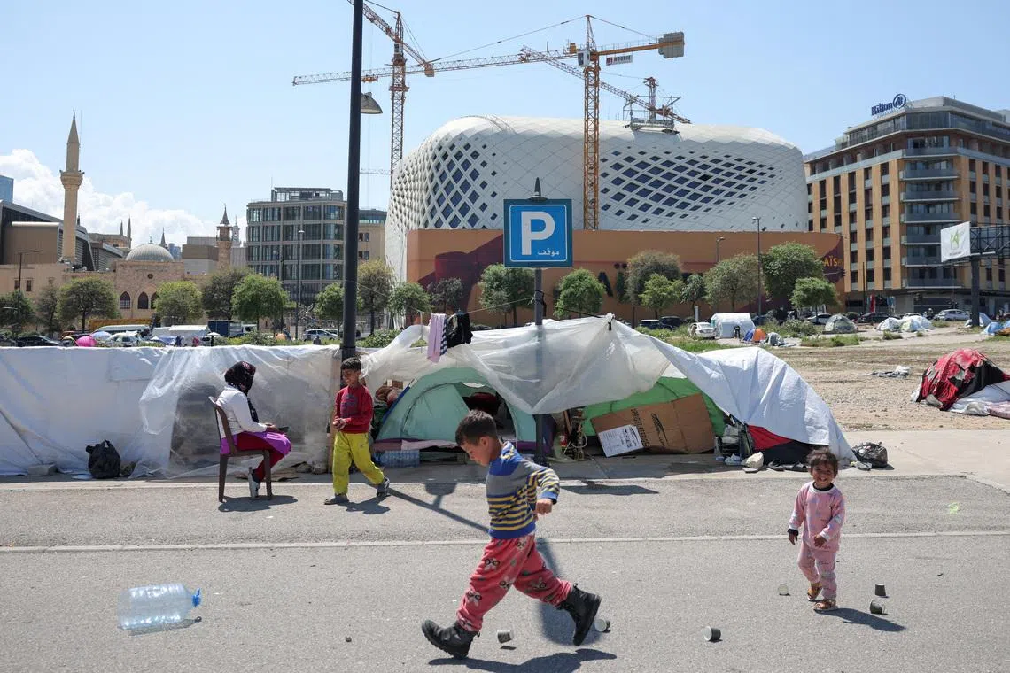 Displaced children, who fled their homes after Israeli evacuation orders, play by their tents at their makeshift encampment in Beirut, Lebanon, April 8, 2026. 