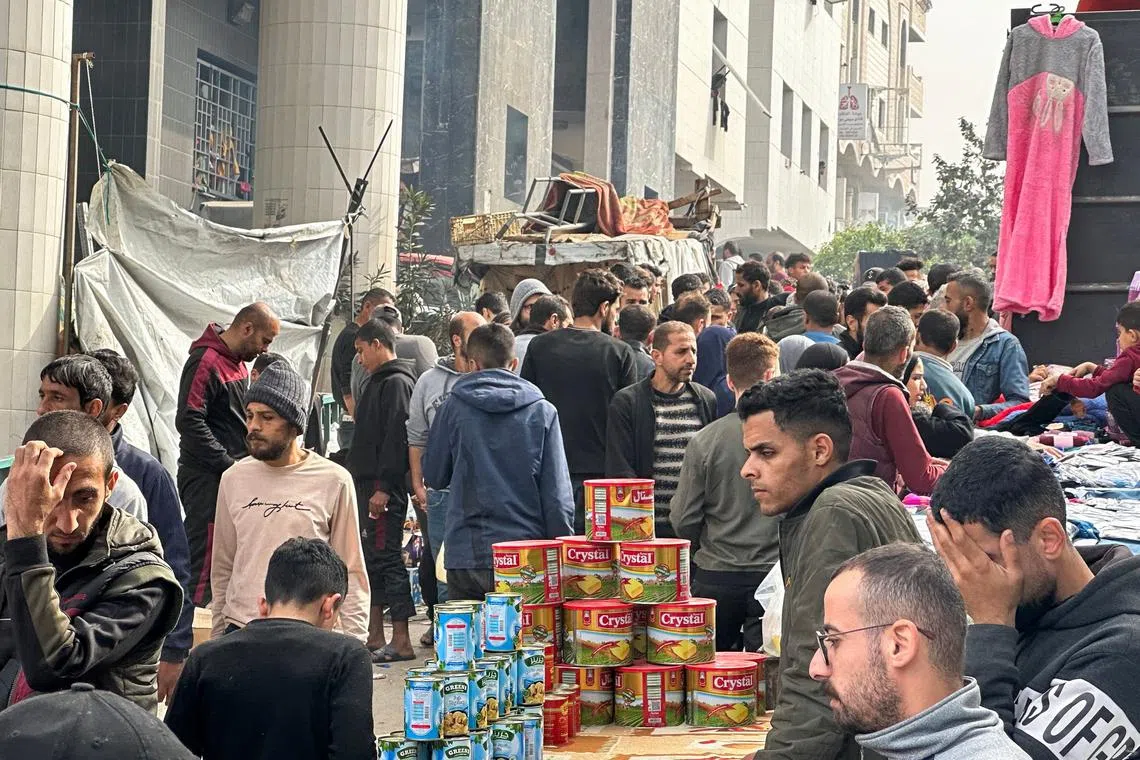 Displaced Palestinians gather in the yard of Gaza's Al-Shifa hospital on Dec 10, 2023.