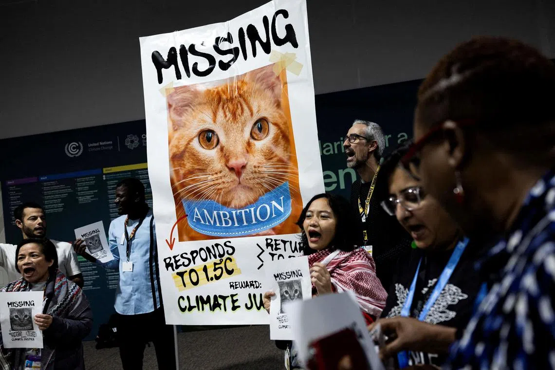 Activists perform a protest action at the COP29 United Nations climate change conference, in Baku, Azerbaijan November 21, 2024. REUTERS/Maxim Shemetov     TPX IMAGES OF THE DAY     