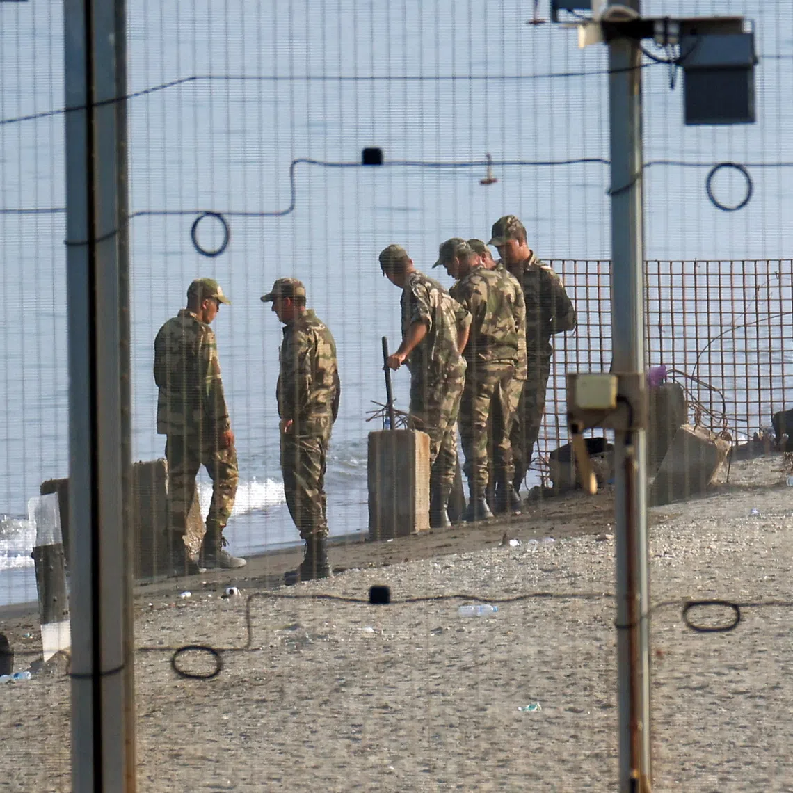 Military personnel work on the border with Morocco in Ceuta on Aug 14, following mass crossings of migrants on foot and by sea from Morocco into Spanish territory, Ceuta.