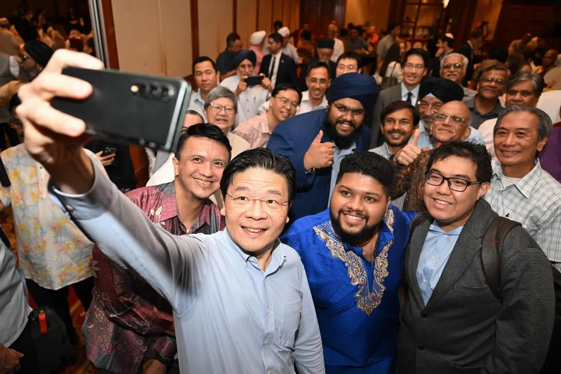 Deputy Prime Minister Lawrence Wong taking a we-fie with guests at the Inter-Religious Organisation (IRO) 75th Anniversary at Raffles Town Club on Jan 23, 2024. ST PHOTO: SHINTARO TAY