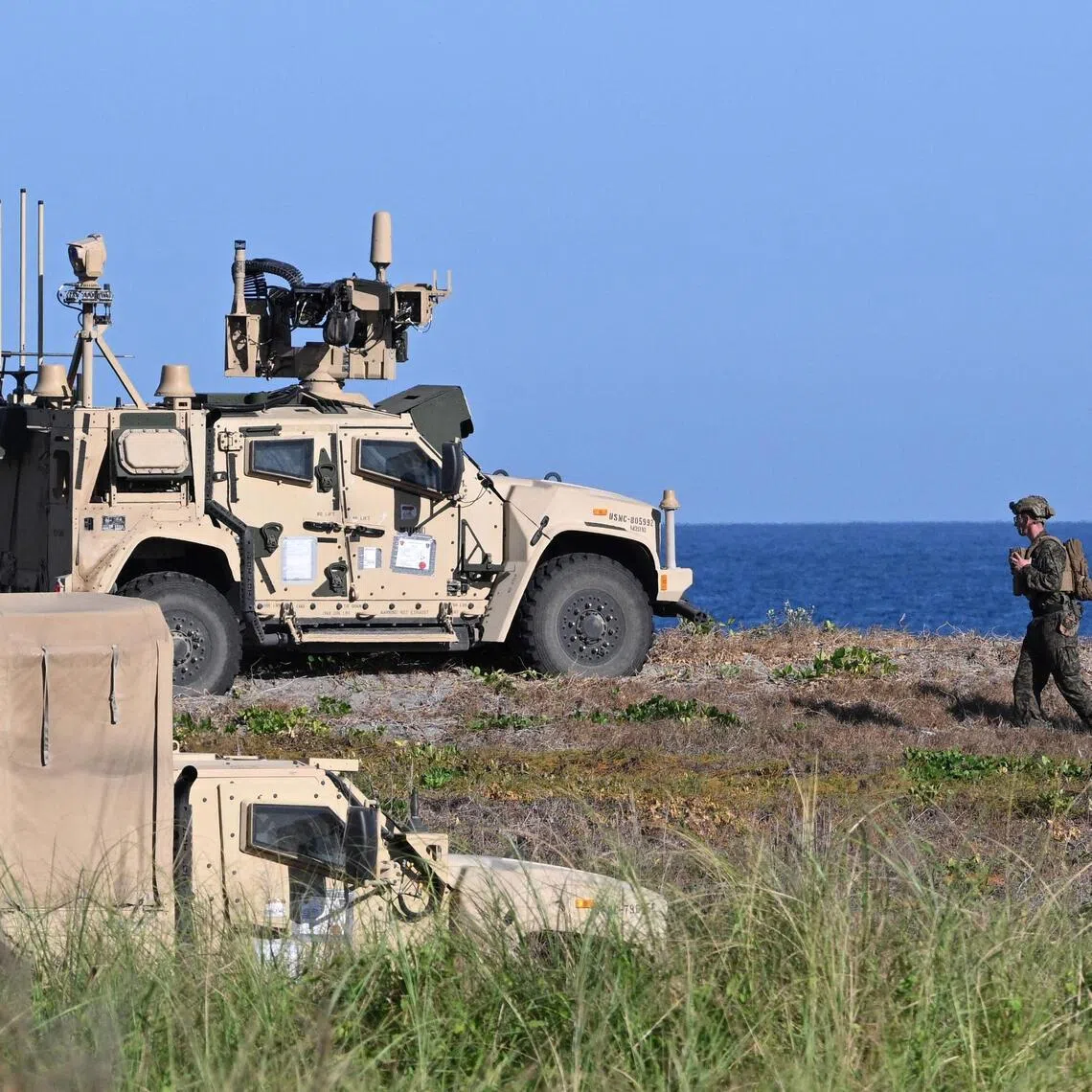 US marines walking past a Marine Air Defence Integrated system launcher during the integrated missile exercise as part of the Balikatan joint Philippines and US military exercise at a naval base facing South China Sea.