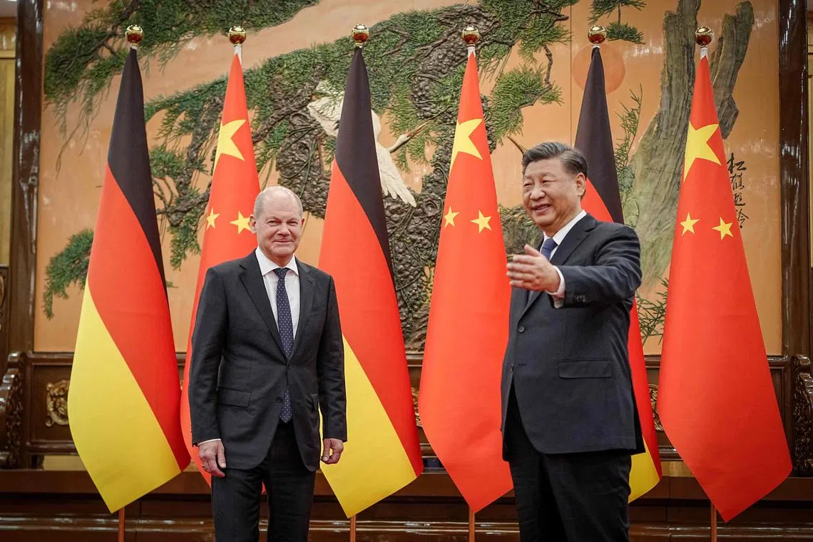 Chinese President Xi Jinping (R) welcomes German Chancellor Olaf Scholz at the Great Hall of the People in Beijing on November 4, 2022. (Photo by Kay Nietfeld / POOL / AFP)